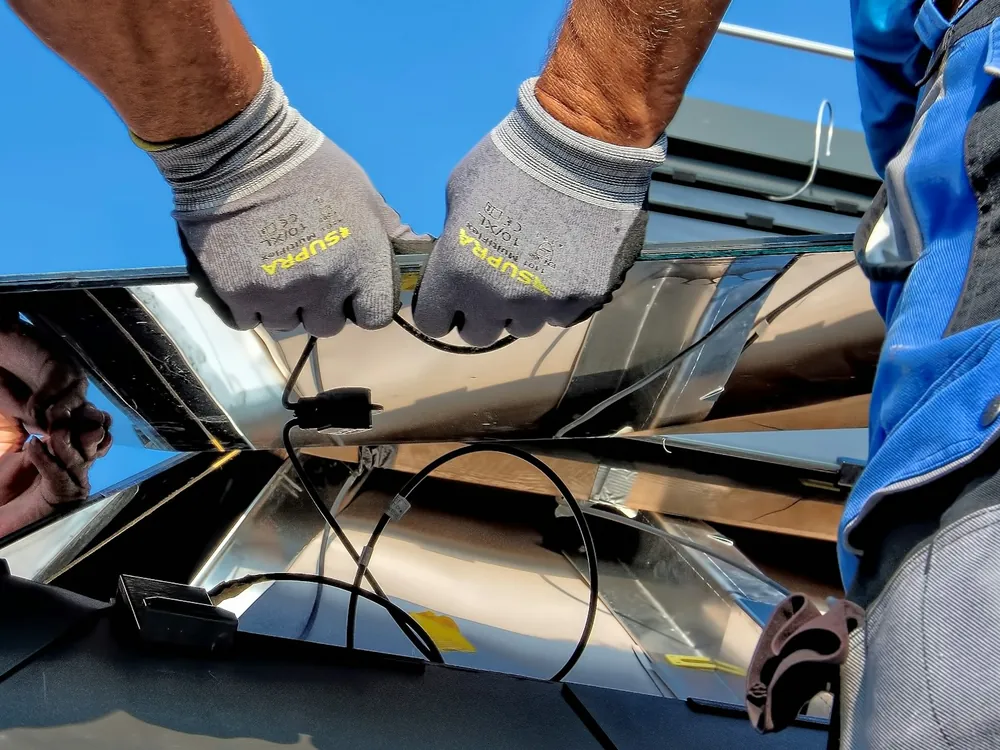 A solar panel being fixed to its metal frame
